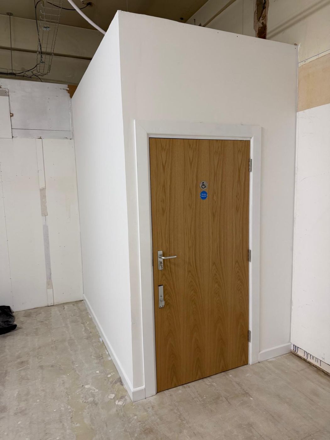 After: finished accessible WC with oak fire door